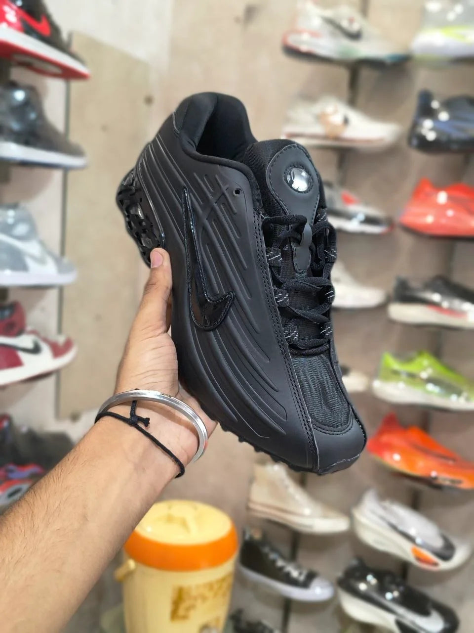 Nocta-style black casual sneakers side view