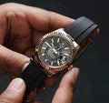 Side profile of automatic watch with black strap