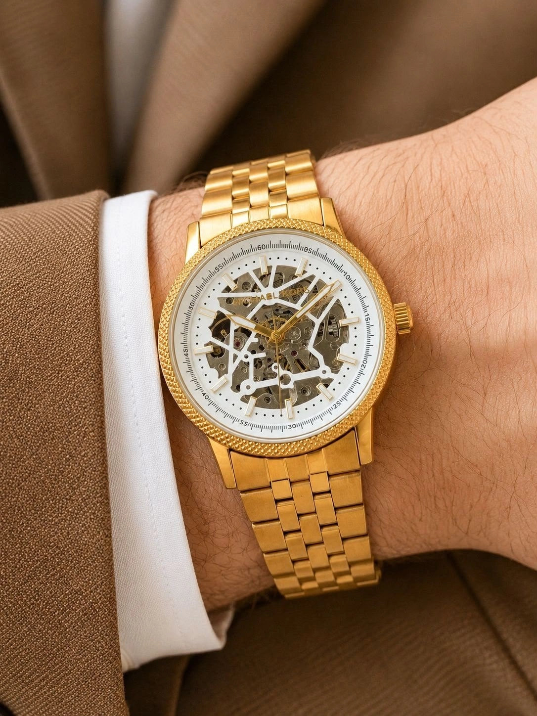 Gold-tone watch with open-worked dial and mechanical movement