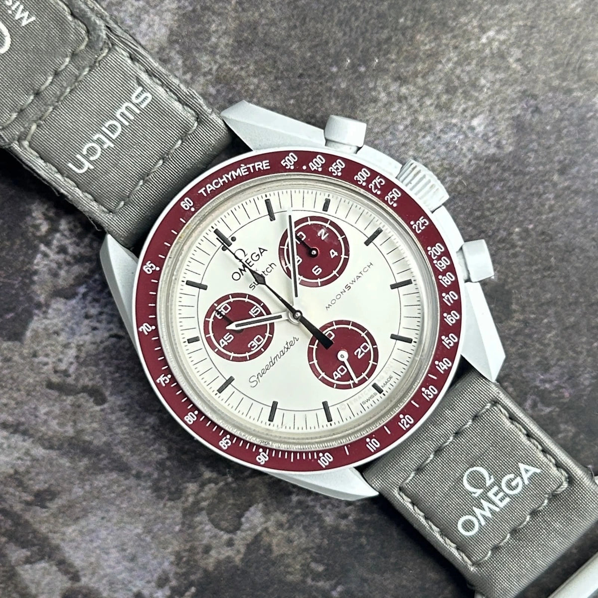 Space-themed wristwatch with tachymeter-style bezel.