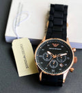 Rose-tone case and black strap watch detail