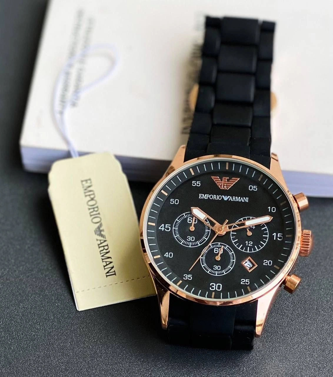 Rose-tone case and black strap watch detail
