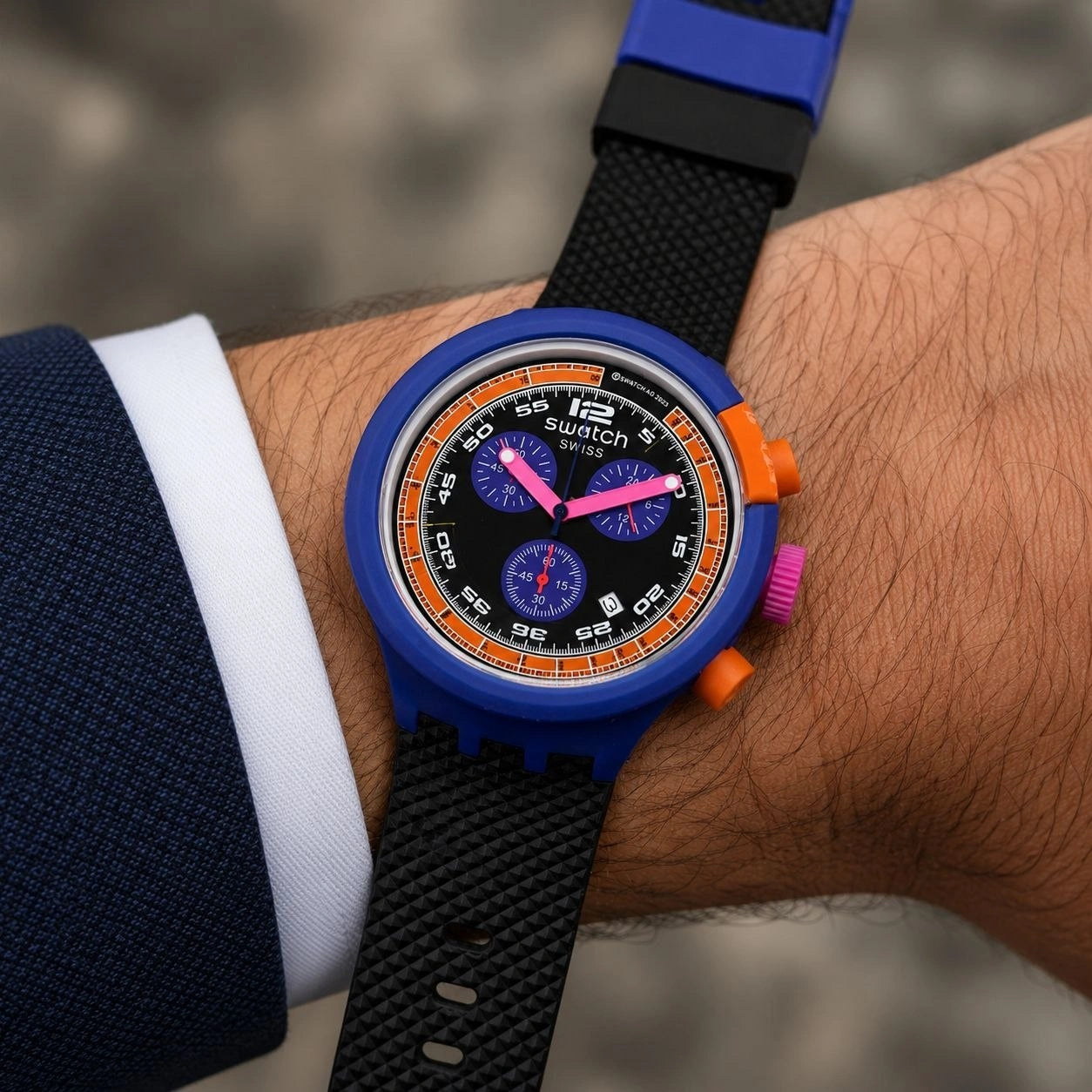 Blue Swatch watch with black dial and chronograph display